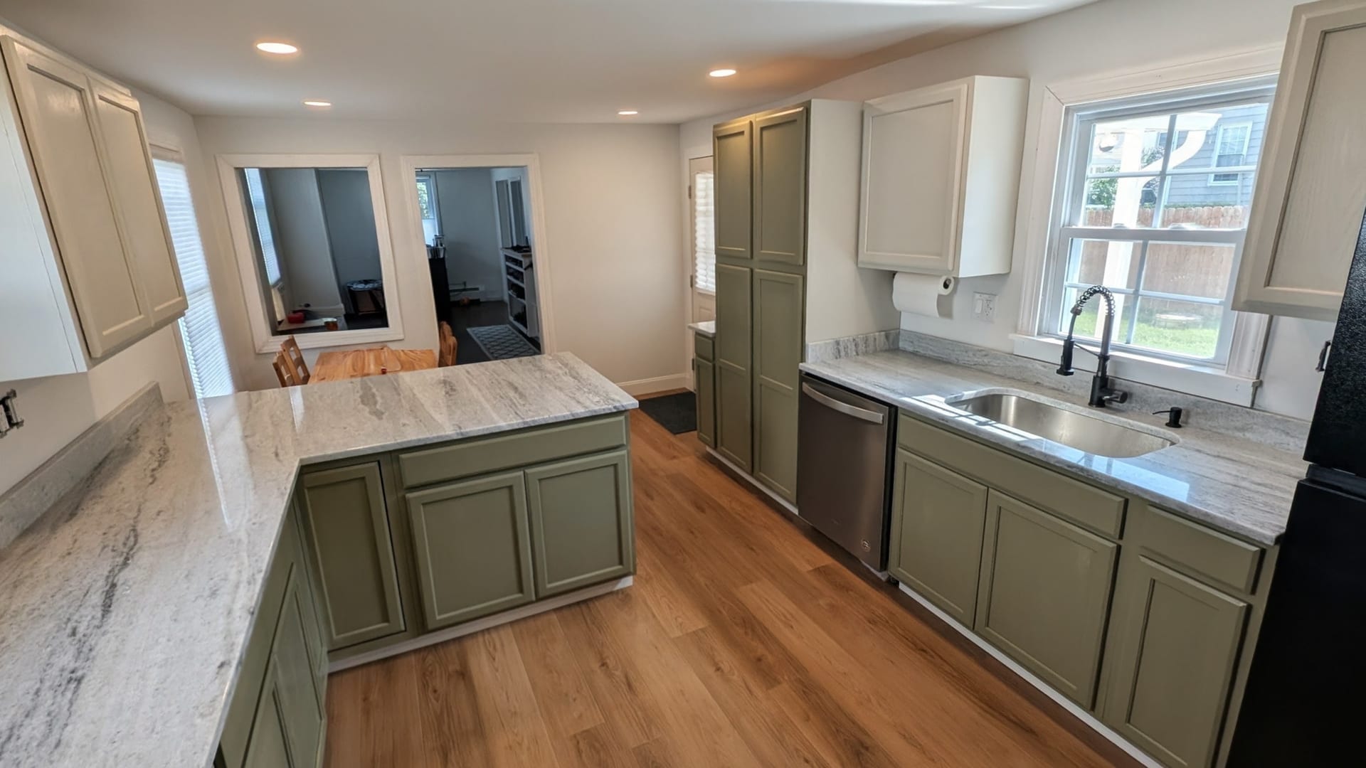 Kitchen Fixture & Floor Finishes — New stainless sink, moisture-resistant flooring, and vibrant modern finishes.