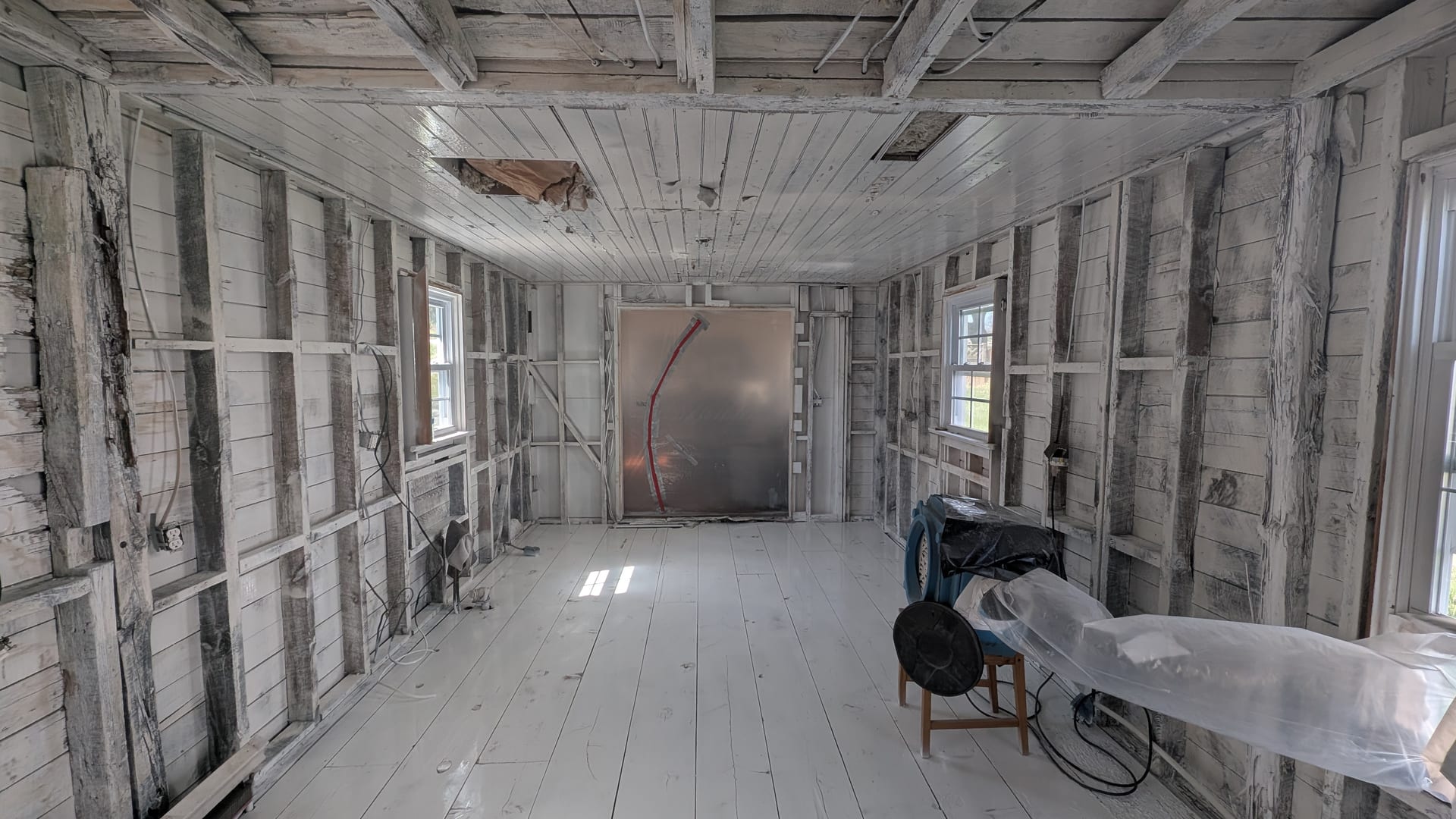 Cleaned wall framing with antimicrobial sealant coat